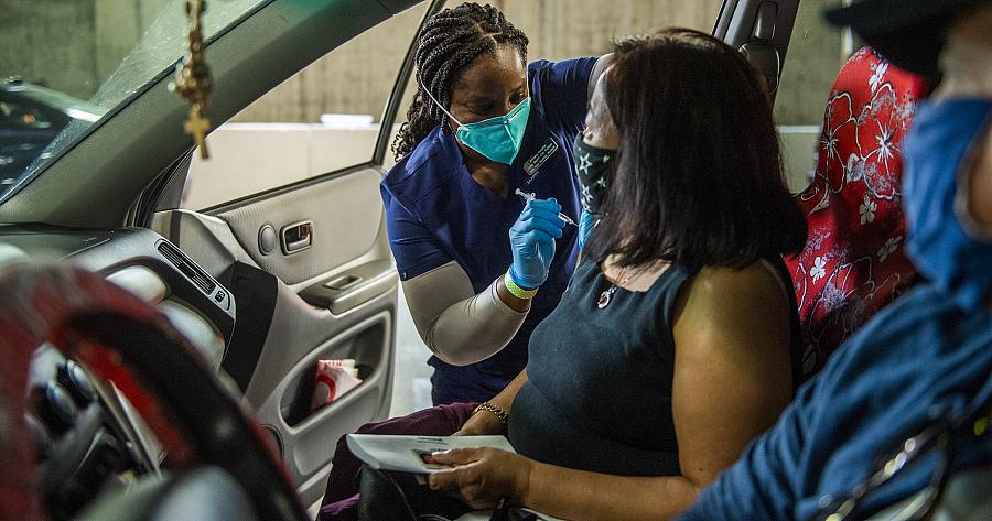  Amaka Iheaka gives a shot to Yolanda Penaflor at a COVID-19 vaccination clinic at the Long Beach Convention Center on April 1, 