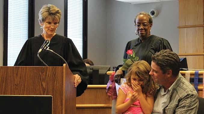 Judges Julia Garratt (far left) and Patricia Clark (center) at a family treatment court graduation in Seattle. 