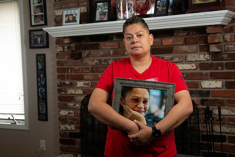  Daisy Duarte holds a photo of her mother, Sonia Calderon, who died earlier this year from Alzheimer's disease. 