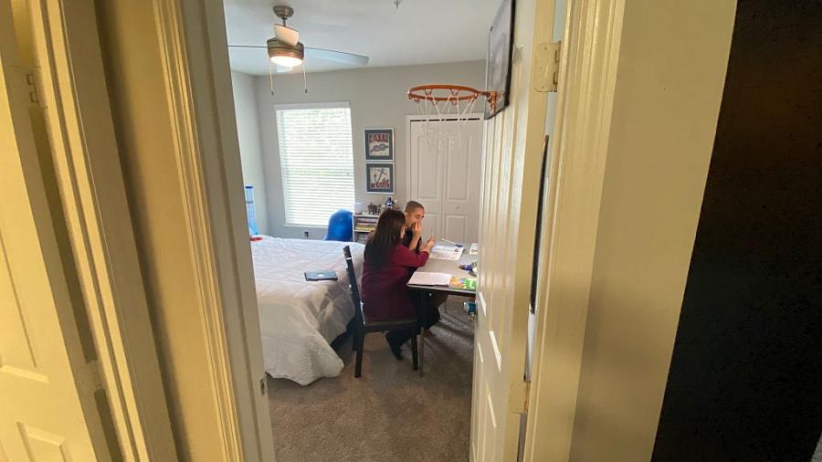 Aracelis Bonet, 50, home schools her son Adam Martinez, 14, who is affected by severe autism, in their home on October 1, 2020. 