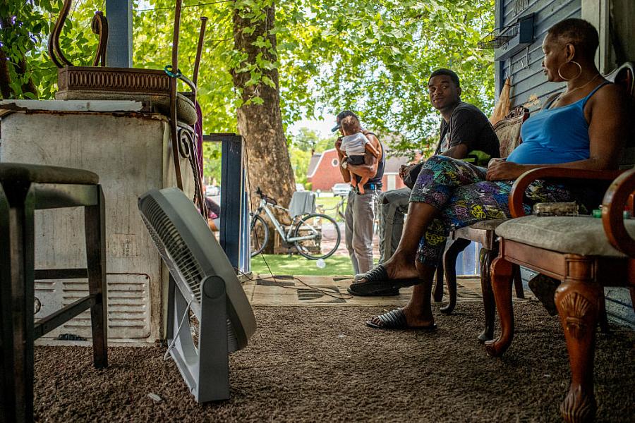 Yvette Johnson and her family outside of her home during a heatwave in July 2022 in Houston, Texas. "It’s too much heat inside m