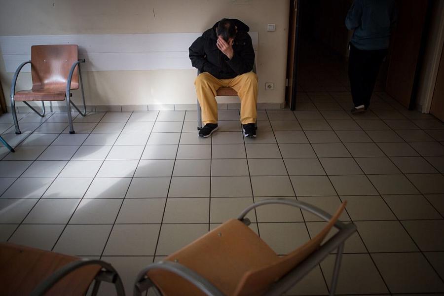 Man seated in clinic waiting room