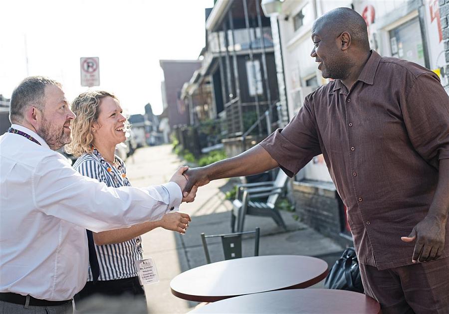 John O'Dowd, left, and Catriona Milosevic, of the UK's National Health Service, meet with grocer Carl Lewis. (Photo: Pittsburgh Post-Gazette) John O'Dowd, left, and Catriona Milosevic, of the UK's National Health Service, meet grocer Carl Lewis.