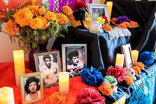 Photographs of loved ones adorn a Day of the Dead ofrenda inside the Indio Senior Center in Indio, California, on November 2, 20