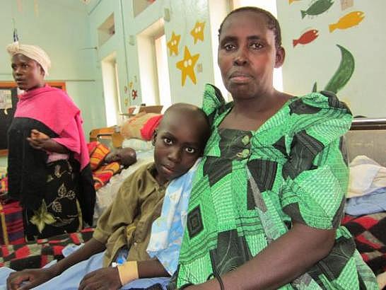 Mother and son in the children's ward at Uganda Cancer Institute