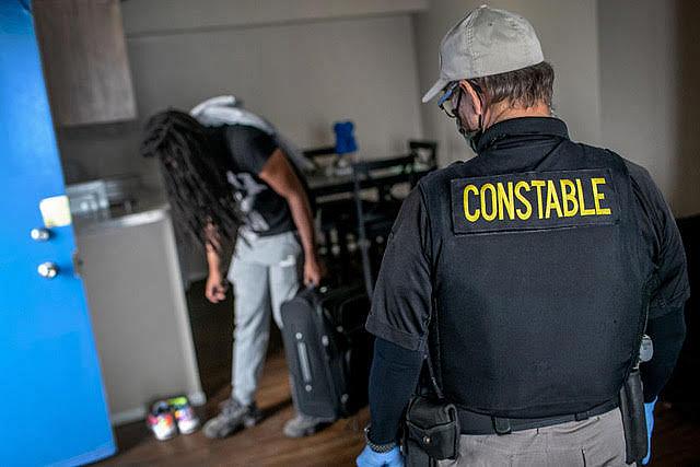 A Maricopa County constable evicts an apartment resident for nonpayment of rent in Phoenix, Arizona. 