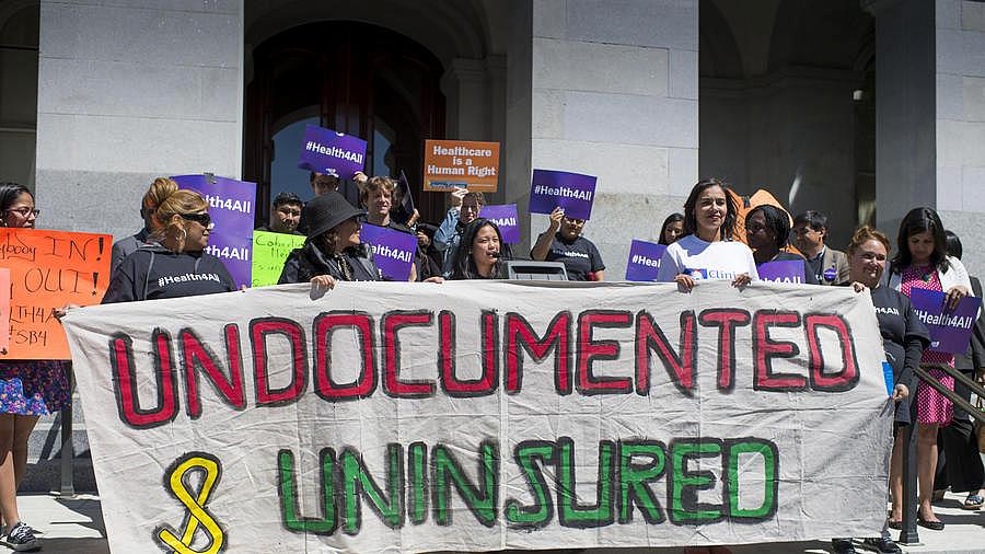 Advocates for a bill to provide health care to undocumented immigrants rally in at the Capitol in Sacramento. (Photo by LA Times/Hector Amezcua)