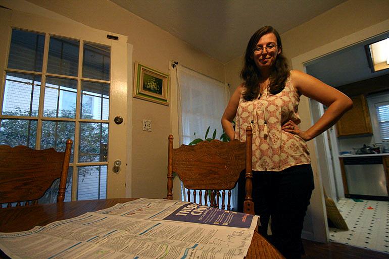 Mary O’Connor, 24, of Sacramento, who voted “yes” on California’s proposition 61, looks at a voter guide she used to help her fi