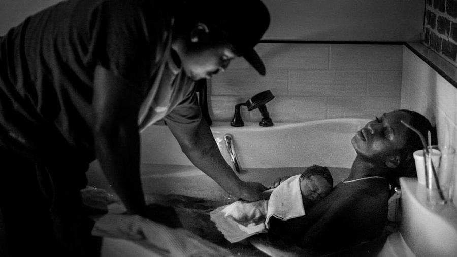 Aysha-Samon Stokes rests in the birthing bath at Kindred Space LA’s South LA birthing center on Mother’s Day, 2021.