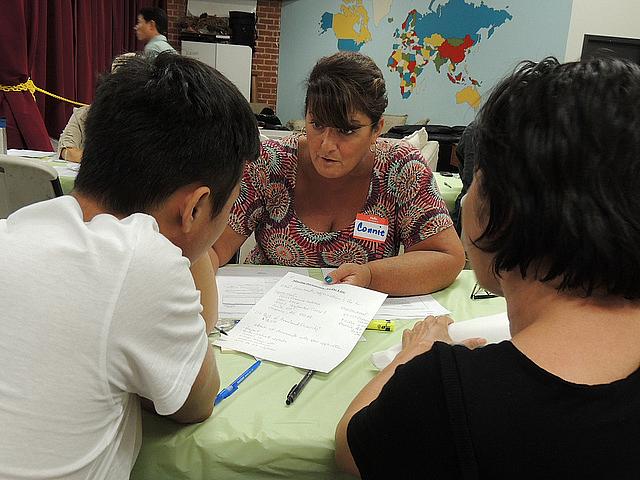 A family receives information at a workshop on Deferred Action.