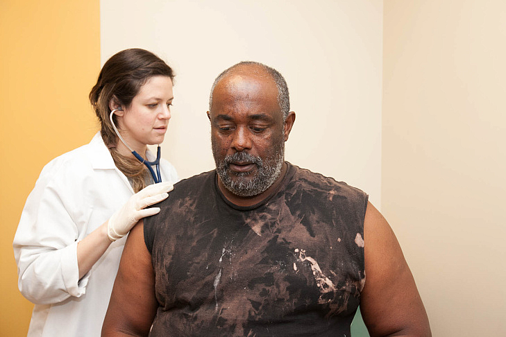 Dr. Samantha Smith checks on 58-year-old patient Paul Shelton. He has severe liver scarring as a result of hepatitis C, but his 