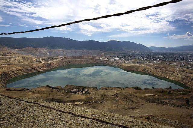 The toxic Berkeley Pit, shown here with the city of Butte in the background, is part of the largest Superfund site in the United