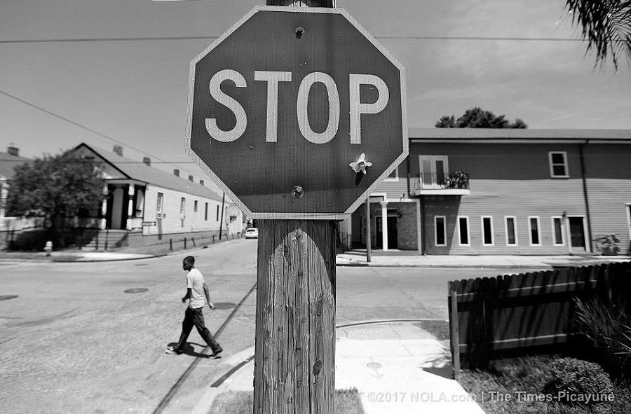 A bullet hole in a stop sign at the corner of Dryades and Fourth streets is a daily reminder of violence.