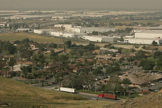 Homes sit near warehouses and Highway 60 in Jurupa Valley. Warehouses have proliferated in western San Bernardino and Riverside counties on former dairy land in Jurupa Valley.