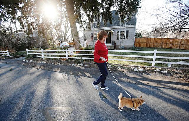 Charlotte Jensen, 77, walks her dog Spike near her home in Salt Lake City. She called the Encore Chorale a "godsend" because she's missed singing and meeting new people. Nov. 26, 2013.