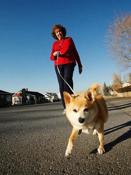 Charlotte Jensen, 77, walks her dog Spike near her home in Salt Lake City, Nov. 26, 2013. Staying healthy and engaged helps prevent loneliness.