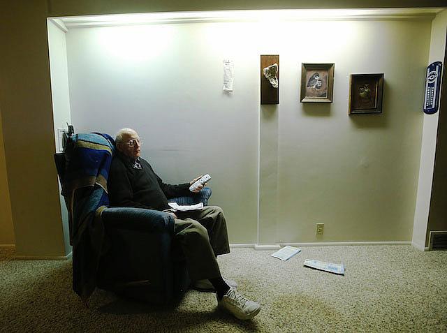 Roger Thompson, 99, watches TV at his home in Salt Lake City, Friday, Dec. 3, 2013. Thompson stays active in his church and neighborhood, which wards off loneliness. 