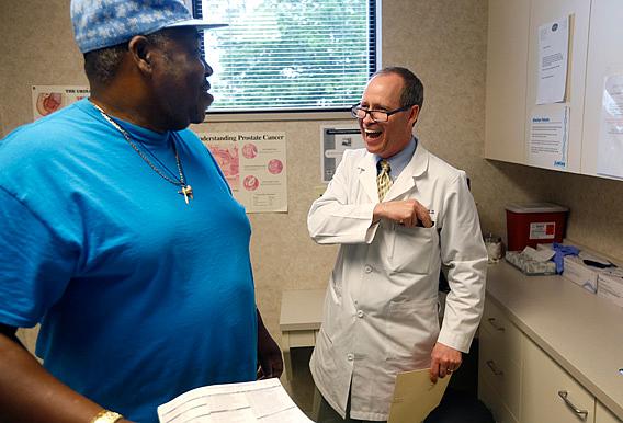 Dr. Greg Murphy laughs with with patient Mickey Wooten. Murphy says he fears that not only are the recommendations against prostate screenings contributing to the deaths of black men, but white ones, too. Ethan Hyman / ethan.hyman@newsobserver.com