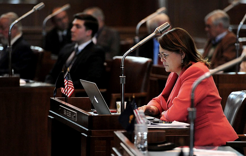 (Brent Drinkut | Statesman-Journal via AP) In this Feb. 2, 2015, photo, Sen. Sara Gelser, D-Corvallis, sits at her desk during the opening day of the Oregon legislative session at the Capitol in Salem, Ore.