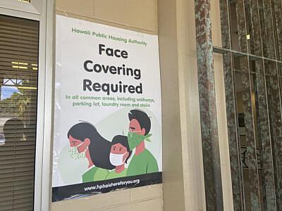 A sign at Kuhio Park Terrace urges everyone to wear face masks.