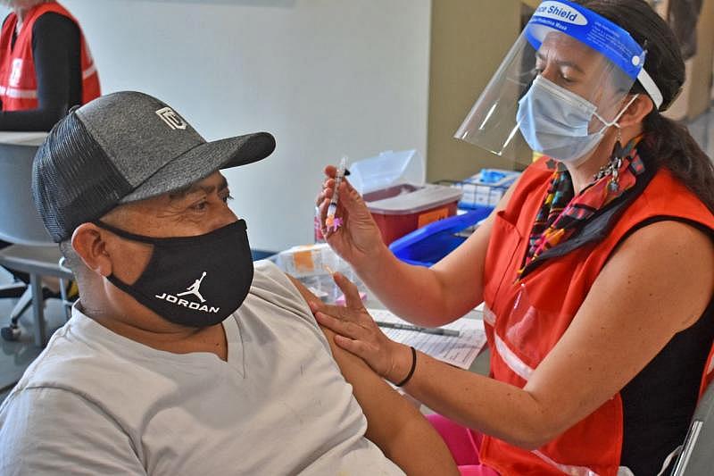 Pedro Martinez, a Santa Barbara County agriculture worker, receives a COVID-19 vaccine from nurse Morena Loomis during a pilot vaccination clinic hosted by the Santa Barbara County Public Health Department in Santa Maria on Feb. 28.  (Janene Scully / Noozhawk photo)