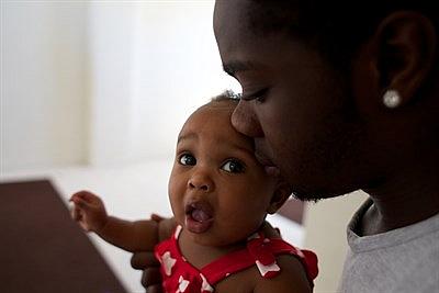 Will Pollard holds his daughter, Harmony. Andrew Nixon/Capital Public Radio