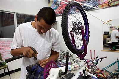 Geronimo Garcia repairs bicycles part time at a community center near his home. Andrew Nixon/Capital Public Radio