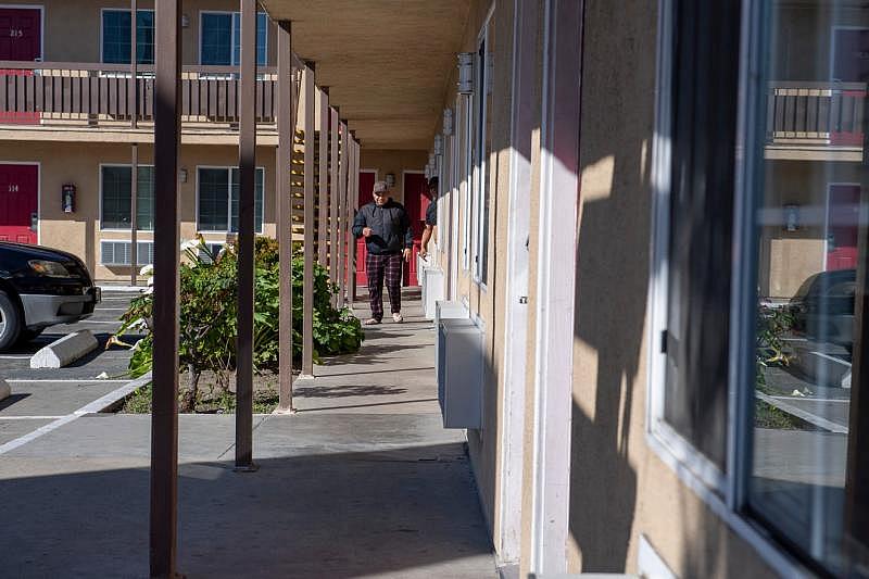 An H2A worker walks passed another persons room inside the Budget Inn Motel in Salinas on April 2, 2020. David Rodriguez/ The Salinas Californian 