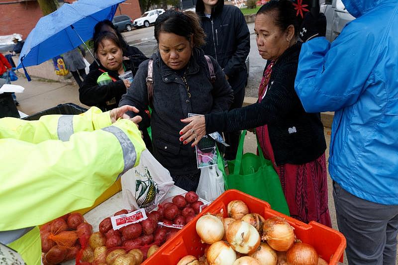Residents of the Marshall Island community living in Iowa take advantage of a pre-COVID food program to purchase items at a farmer’s market October 5, 2019 in Dubuque, Iowa. | M. Scott Mahaskey / POLITICO