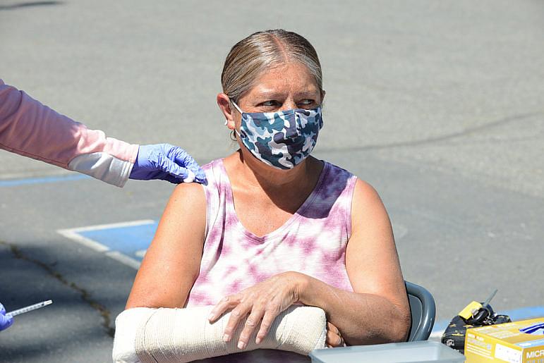 Annette Tuttle of Covelo receives the Pfizer-BioNTech COVID-19 vaccine at Round Valley High School in Covelo. Mendocino County Public Health conducted their first COVID-19 vaccination clinic in Covelo on April 21, 2021. (Dana Ullman / The Mendocino Voice)