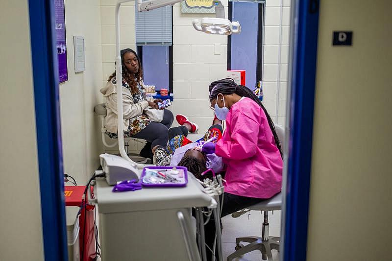 A Joe Louis Street single mom Kisha Simms spends an afternoon at home with her girls, and takes the younger one DeeDee, 11, to the dentist. ALICIA DEVINE/TALLAHASSEE DEMOCRA