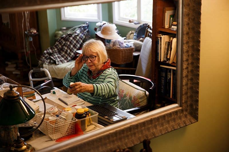 Christie Bilikam works on the daily medicine list for her husband, Ed, and his twin brother, Bob, in July 2021. (Dai Sugano/Bay Area News Group) 