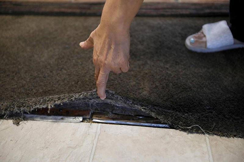 Blanca, an Oceano tenant, lives with old, dirty carpet in her living room. She bought a rug to cover the carpet, which is peeling away from the floor underneath. Laura Dickinson LDICKINSON@THETRIBUNENEWS.COM