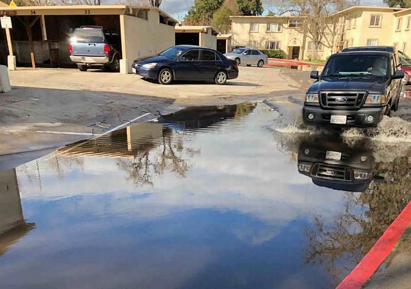 A Paso Robles city staffer sent a photo of deep stagnant water in the parking lot of Grand View Apartments to Building Director Brian Cowen, asking if anything could be done. City emails show Cowen declined to look into the flooding. City of Paso Robles