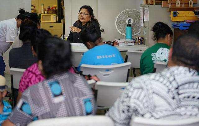 Josie Howard from Chuuk assists her fellow citizens of COFA nations with enrolling in health care insurance at We Are Oceania’s office in Kalihi in December 2018. Cory Lum/Civil Beat
