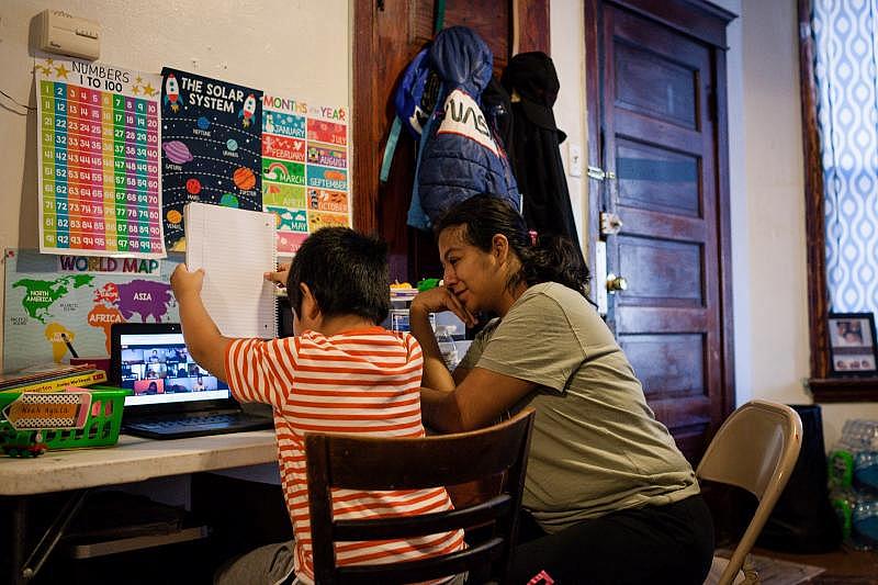 Camarillo decorated her 6-year-old son Noah’s work space to look like a mini classroom, with posters featuring the alphabet and days of the week. Michelle Kanaar / WBEZ