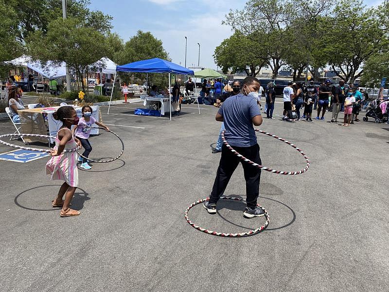 Kids play with hula hoops at a Black Health Fair in North Long Beach on July 24. Photo by Kelly Puente.