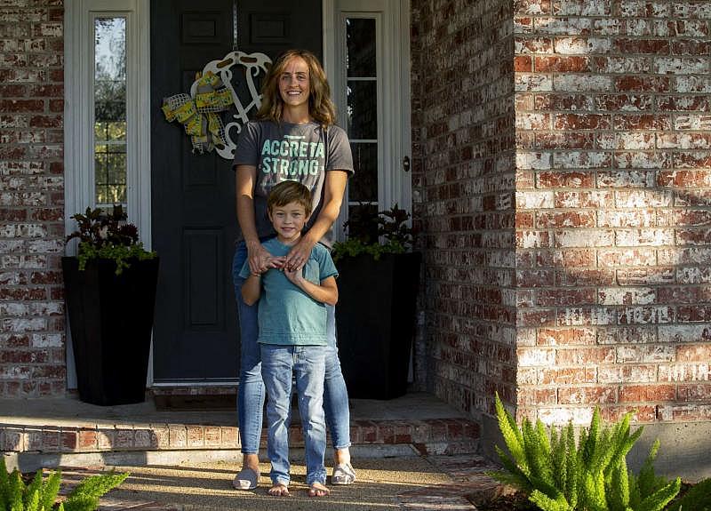 Leah Hood poses for a portrait with her 6-year-old son, Jude. When Hood was pregnant with Jude, she developed a life-threatening pregnancy complication called placenta accreta spectrum, which can cause a woman to bleed out during birth. GODOFREDO A. VÁSQUEZ/STAFF PHOTOGRAPHER