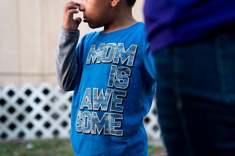 Juliana's son stands with her outside their home in Immokalee. Juliana is an undocumented farmworker, and her family has struggled financially during the pandemic because of limited work and family members contracting COVID-19. ALEX DRIEHAUS/NAPLES DAILY NEWS/USA TODAY - FLORIDA NETWORK
