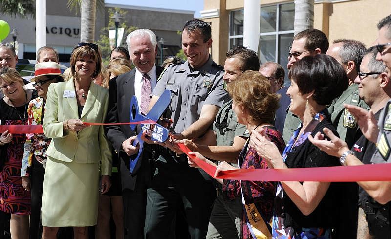 Pasco Sheriff Chris Nocco cuts the ceremonial ribbon during the opening ceremony for a new Sheriff’s Office substation at a local mall. Times (2012)