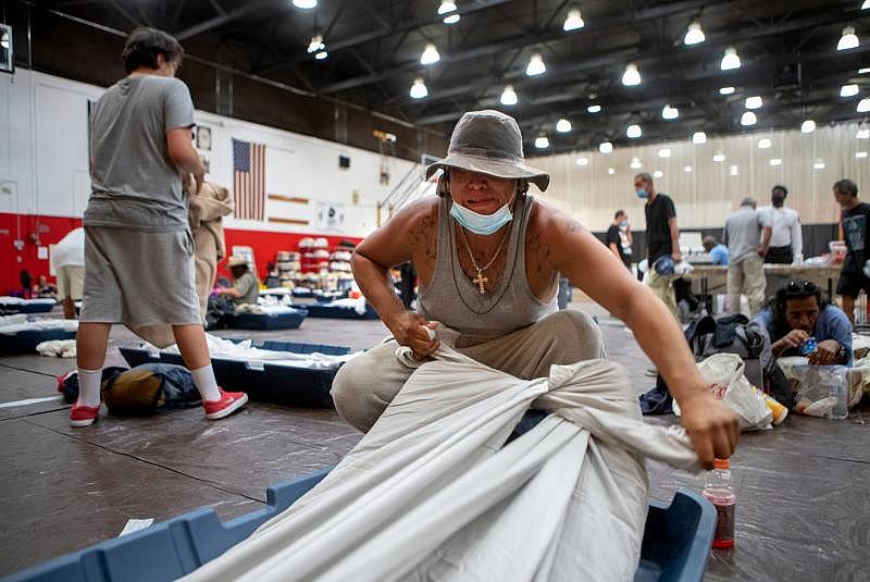 Johnny Alvarez, 47, secures a sheet to his mattress inside the emergency overnight shelter run by the Coachella Valley Rescue Mission inside a portion of the Palm Springs High School Gymnasium on Saturday , June 27, 2020. Taya Gray, Taya Gray
