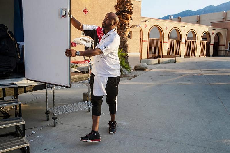 Coachella Valley Rescue Mission employee Charles Dangerfield the third closes the door to the portable shower used by guest staying at the emergency overnight shelter run by the Coachella Valley Rescue Mission inside a portion of the Palm Springs High School Gymnasium on Saturday , June 27, 2020. Taya Gray, Taya Gray