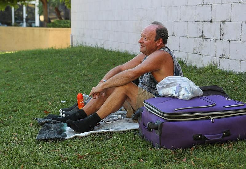 George Smith tries to stay cool during triple-digit temperatures in the shade of a wall at Sunrise Park after the closure of the overnight shelter for the homeless in Palm Springs, September 30, 2020. Jay Calderon/The Desert Sun