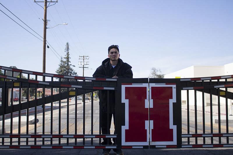 Daniel Leon behind the San Benito High School gate that closes part of Nash Road during school hours. Photo by Noe Magaña.