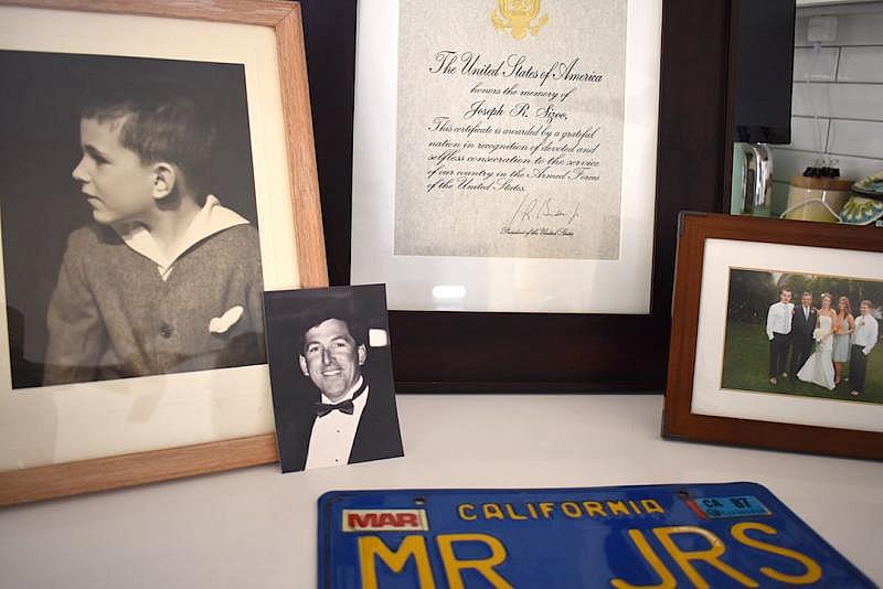Family photos of Joseph Richard Sizoo II, as well as his recognition from President Joe Biden for his naval service and his vintage California license plate with his JRS initials. The license plate had been in his room at Channel Islands Post Acute. (Brooke Holland / Noozhawk photo)