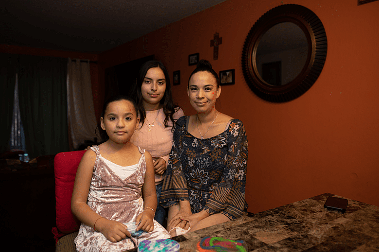 Guadalupe Muñoz with her daughters Carla, 7, and Brittany, 17, in their East Oakland apartment. Credit: Amir Aziz