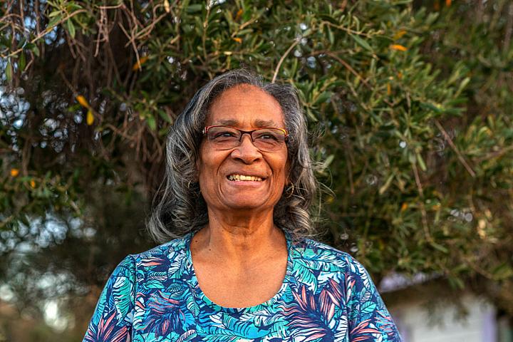 Victoria Gray stands outside her home. Gray and her husband have fostered 41 children and adopted 7. (Credit: Ash Ponders