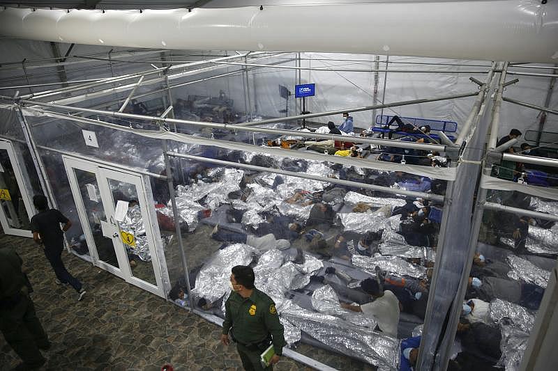 Minors lie inside a pod at a holding facility, called a hielera, for unaccompanied children in Donna, Texas, in March 2021. The facility is run by U.S. Customs and Border Protection. Credit: Dario Lopez-Mills/Associated Press