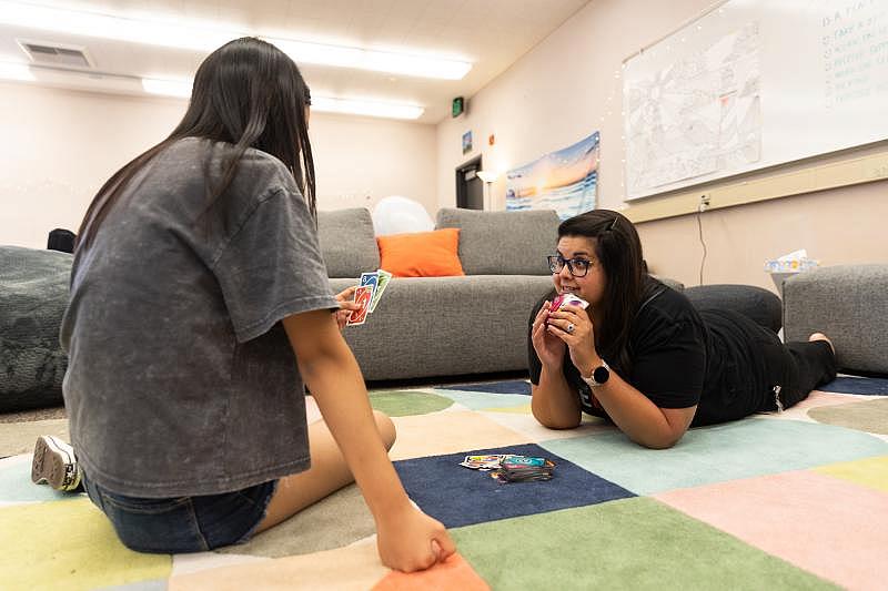 Amrita Vu, the site lead therapist, looks up at senior Julie Chen while they play a game in the Wellness Center at Los Gatos High School in Los Gatos on Aug. 25, 2022. Photo by Magali Gauthier.