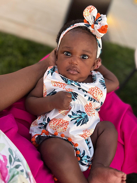 Noni, DeShawna Wright’s daughter, looks at the camera as Wright holds her (Image courtesy of DeShawna Wright).